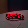 Spider-Man LED lightbox lying flat on a desk with red glow