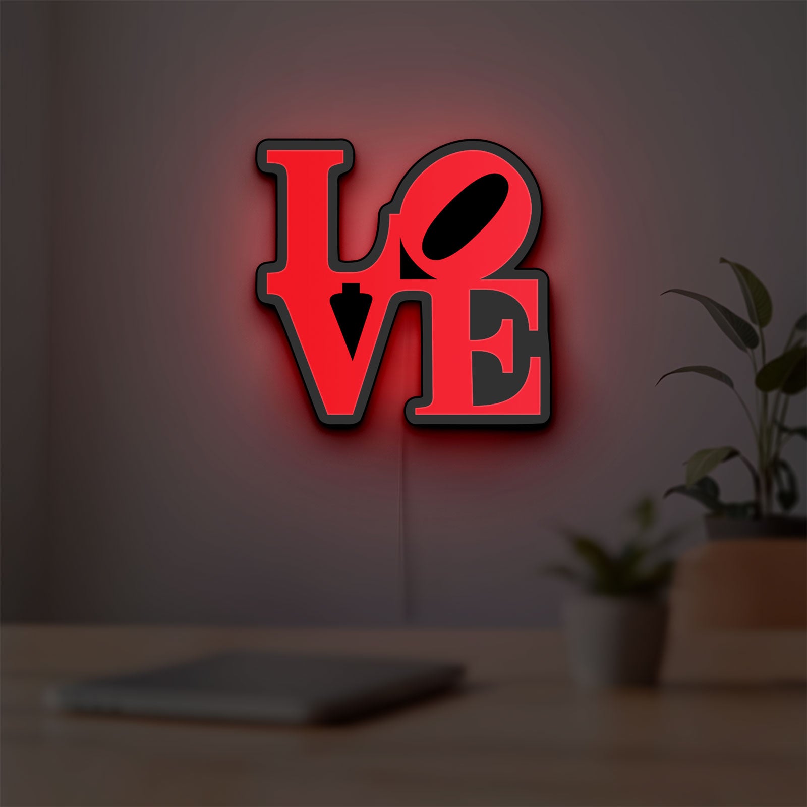 Love LED lightbox hanging on a room wall with soft red light