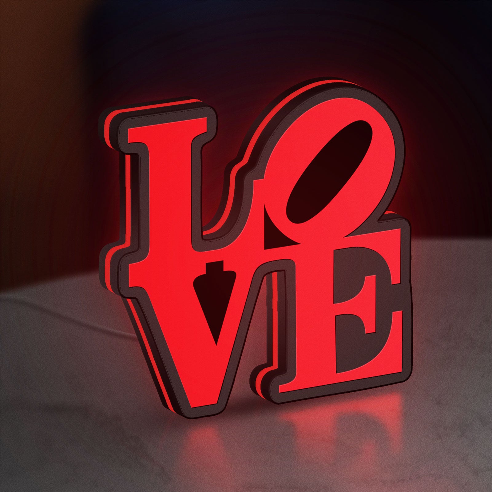 Love LED lightbox standing on a desk from an angled side view with red glow