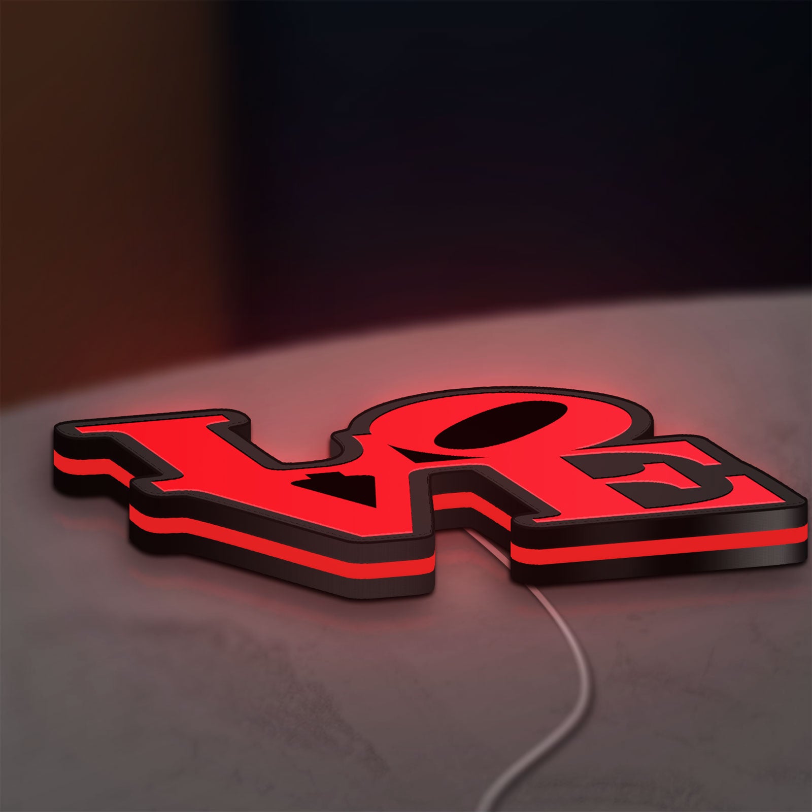 Love LED lightbox lying flat on a desk with red glow