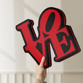 Unlit Love LED lightbox held by hand to show size and details