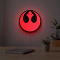 Rebel Alliance LED lightbox hanging on a room wall with soft red light