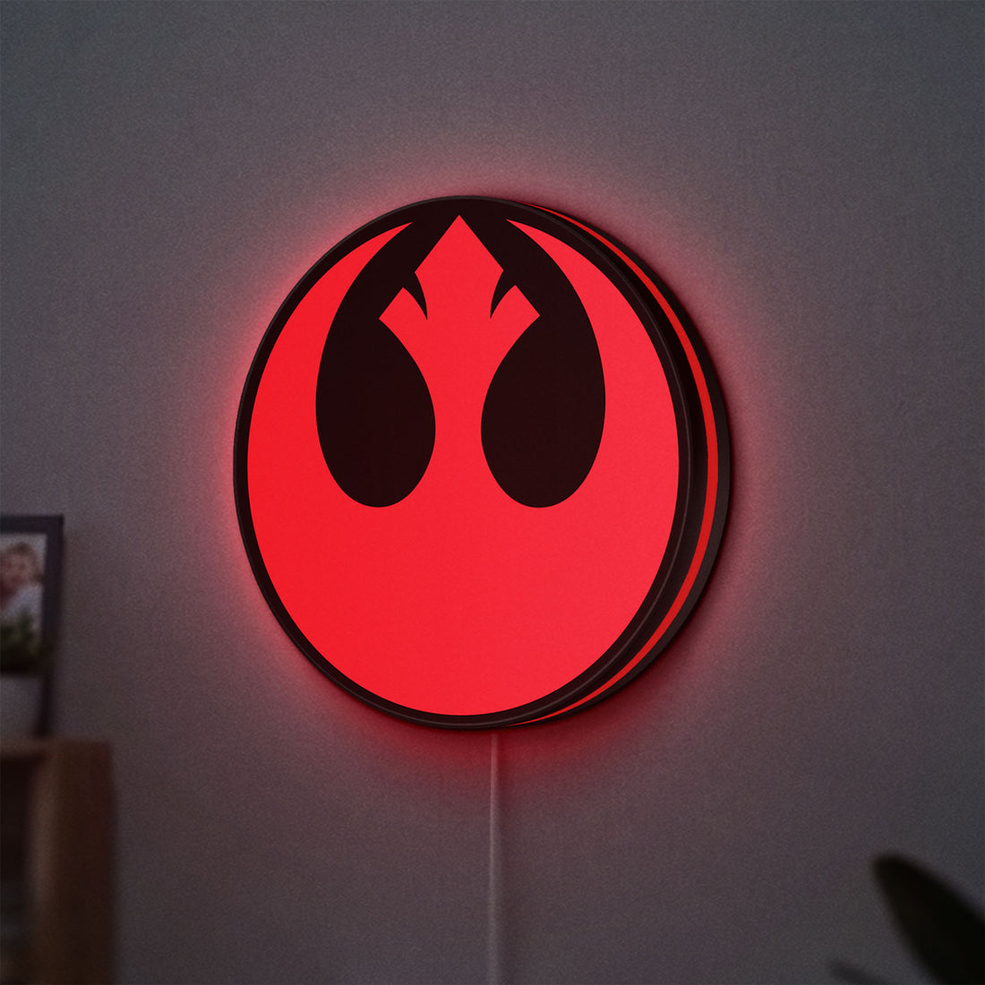 Rebel Alliance LED lightbox hanging on a wall with red glow