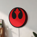 Unlit Rebel Alliance LED lightbox mounted on a wall in daylight