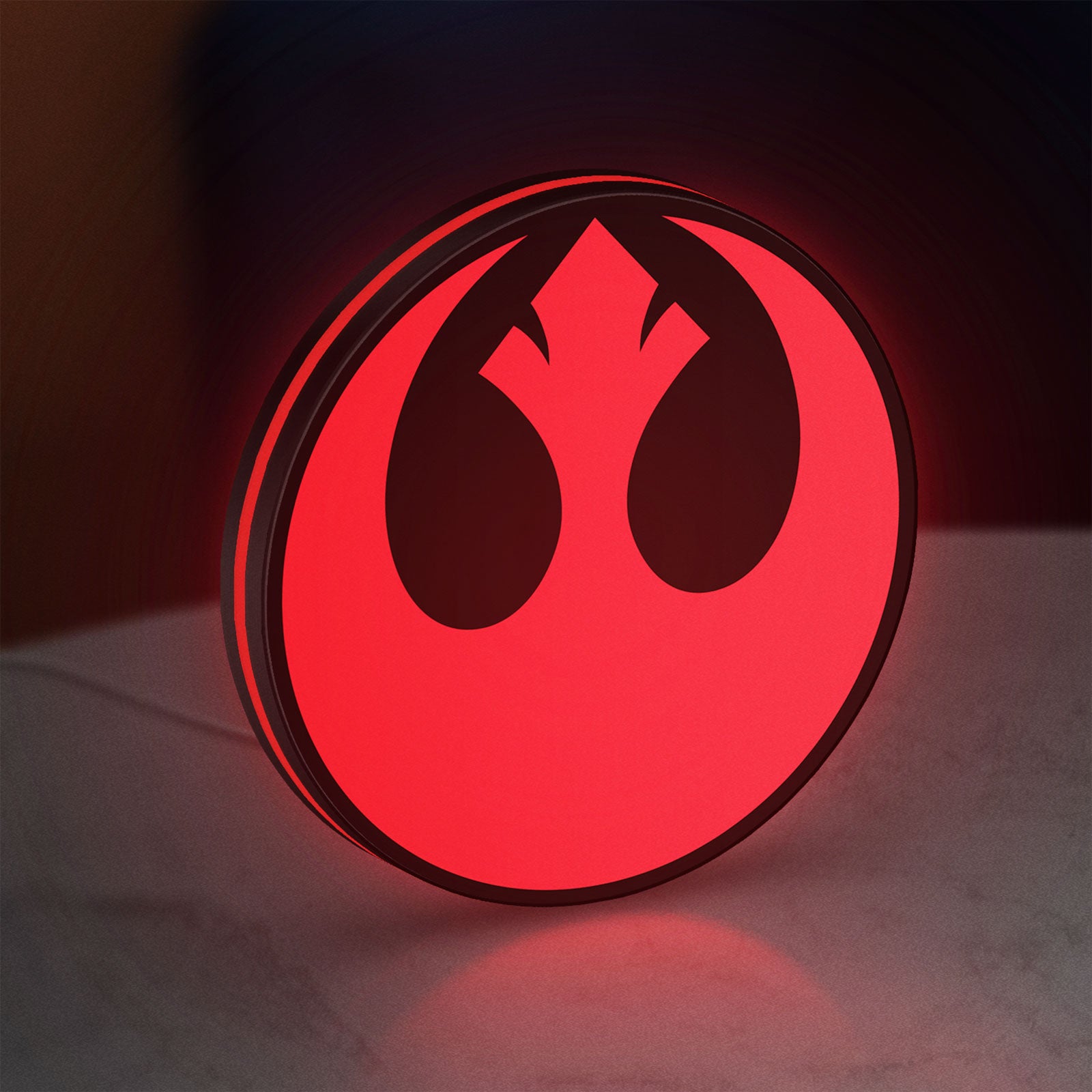 Rebel Alliance LED lightbox standing on a desk from an angled side view with red glow