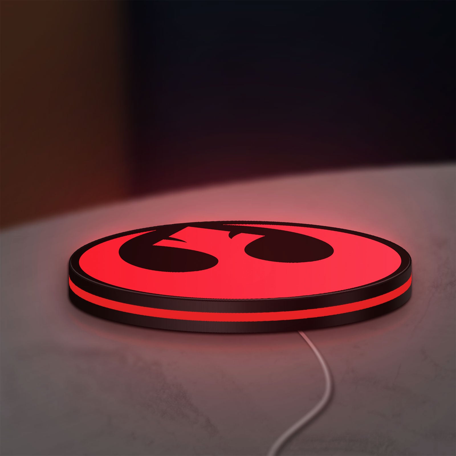 Rebel Alliance LED lightbox lying flat on a desk with red glow