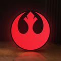 Front view of Rebel Alliance LED lightbox sign glowing on a wooden desk