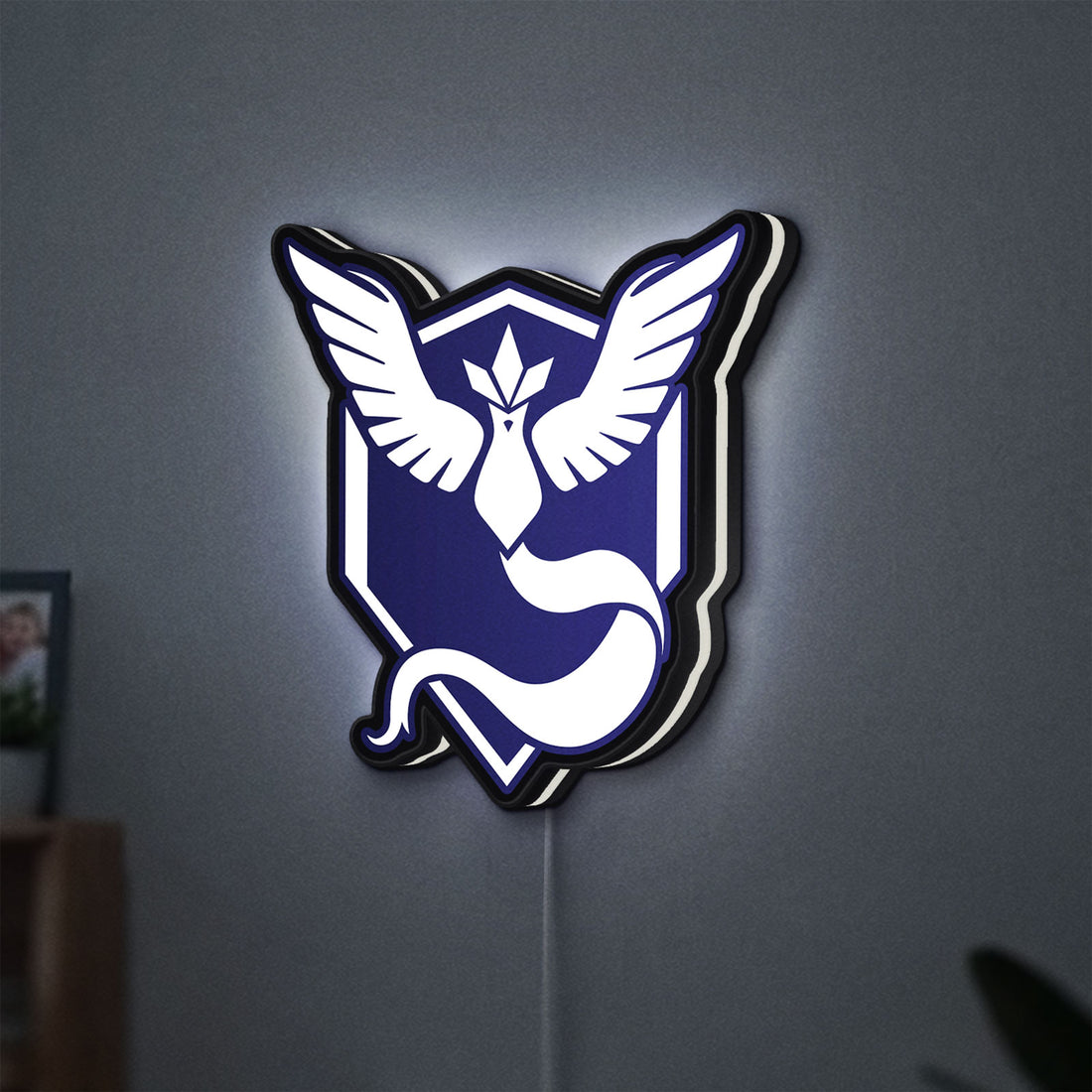 Pokemon GO Team Mystic LED lightbox hanging on a wall with white glow