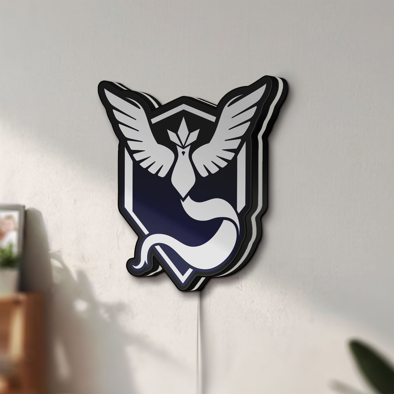Unlit Pokemon GO Team Mystic LED lightbox mounted on a wall in daylight