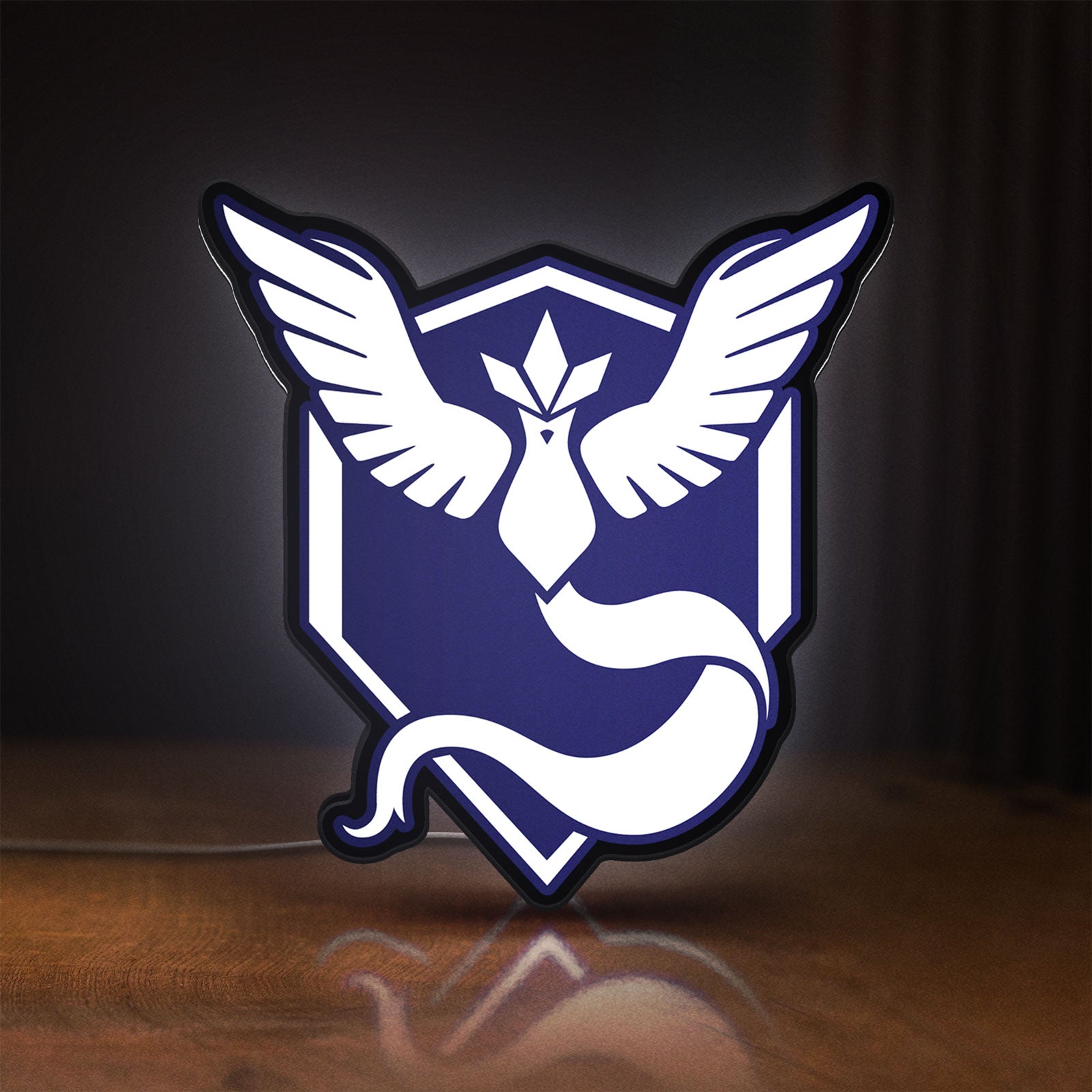 Front view of Pokemon GO Team Mystic LED lightbox sign glowing on a wooden desk
