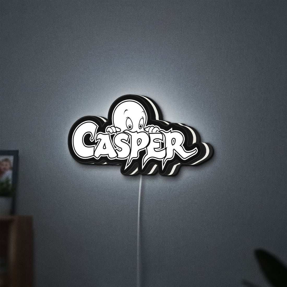 Casper LED lightbox hanging on a wall with white glow