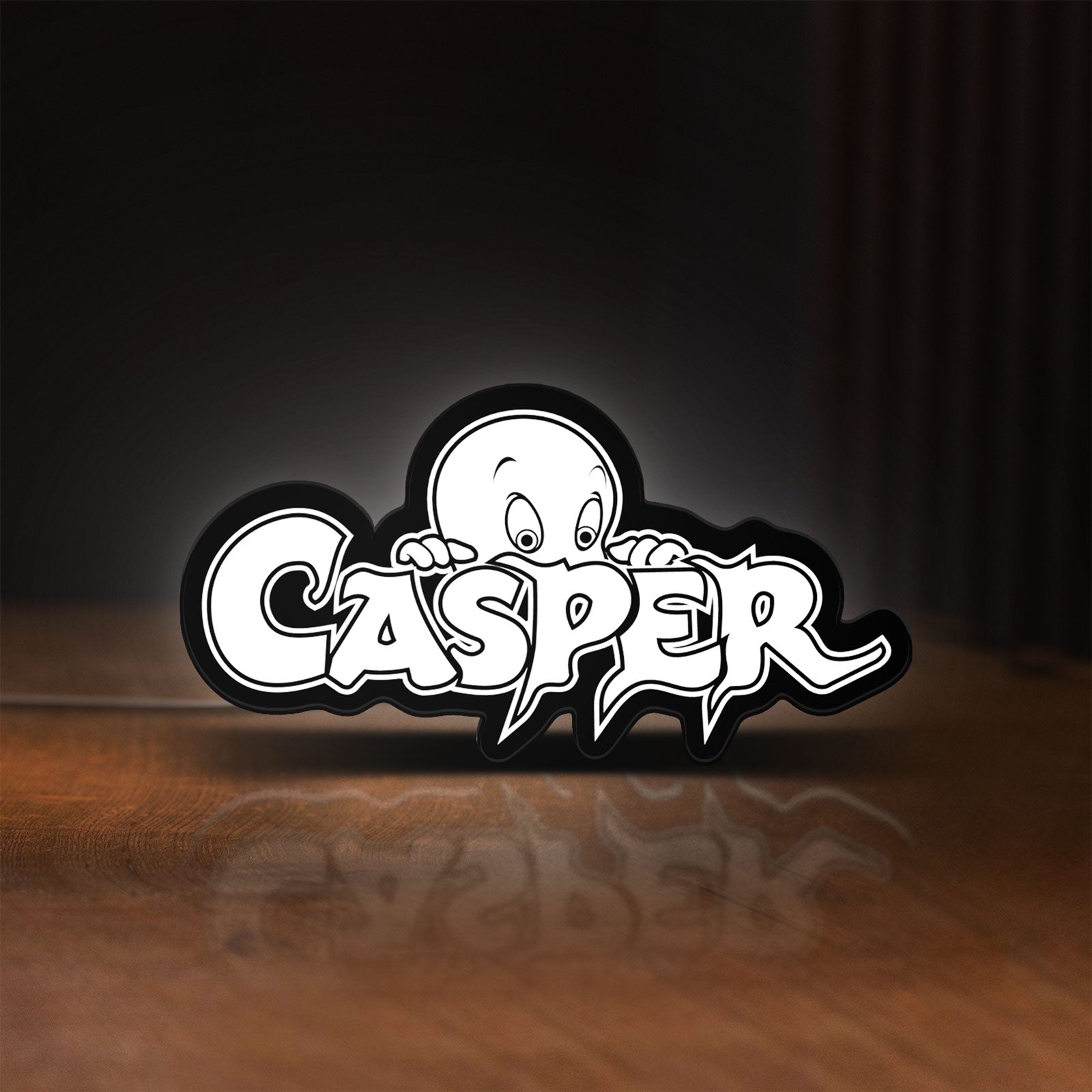 Front view of Casper LED lightbox sign glowing on a wooden desk