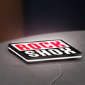 Rock Shox LED lightbox lying flat on a desk with white glow