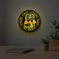 Cobra Kai LED lightbox hanging on a room wall with soft yellow light