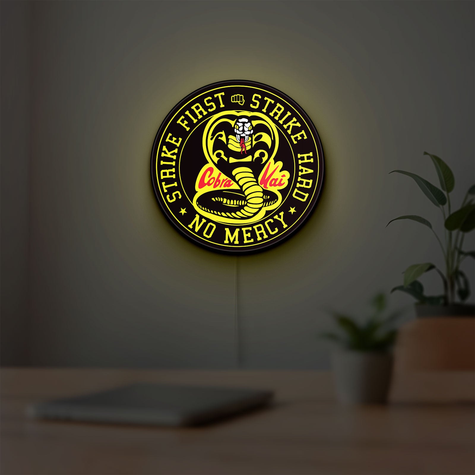Cobra Kai LED lightbox hanging on a room wall with soft yellow light