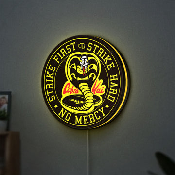 Cobra Kai LED lightbox hanging on a wall with yellow glow