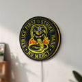 Unlit Cobra Kai LED lightbox mounted on a wall in daylight