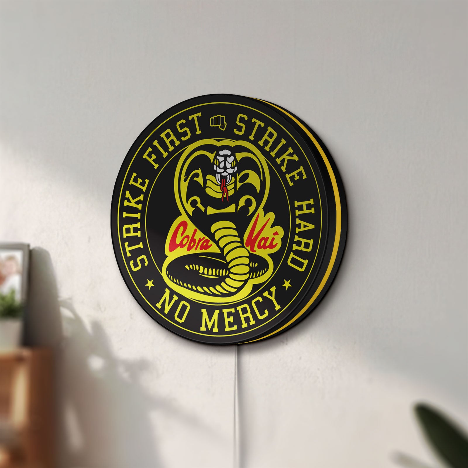 Unlit Cobra Kai LED lightbox mounted on a wall in daylight