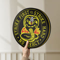 Unlit Cobra Kai LED lightbox held by hand to show size and details