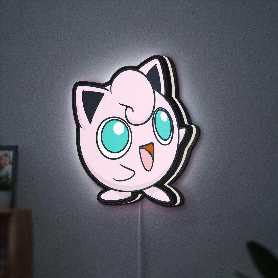 Jigglypuff LED lightbox hanging on a wall with white glow