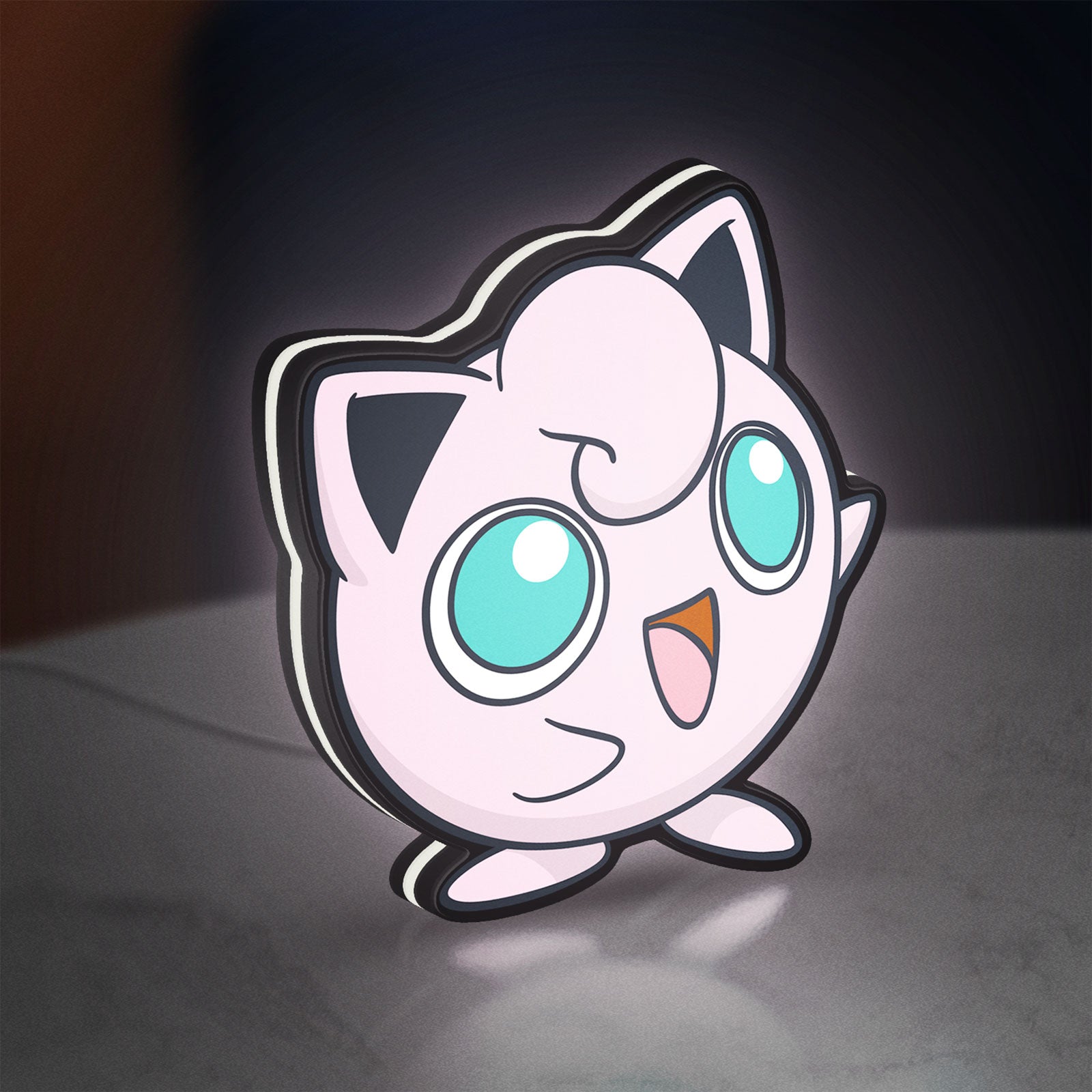 Jigglypuff LED lightbox standing on a desk from an angled side view with white glow
