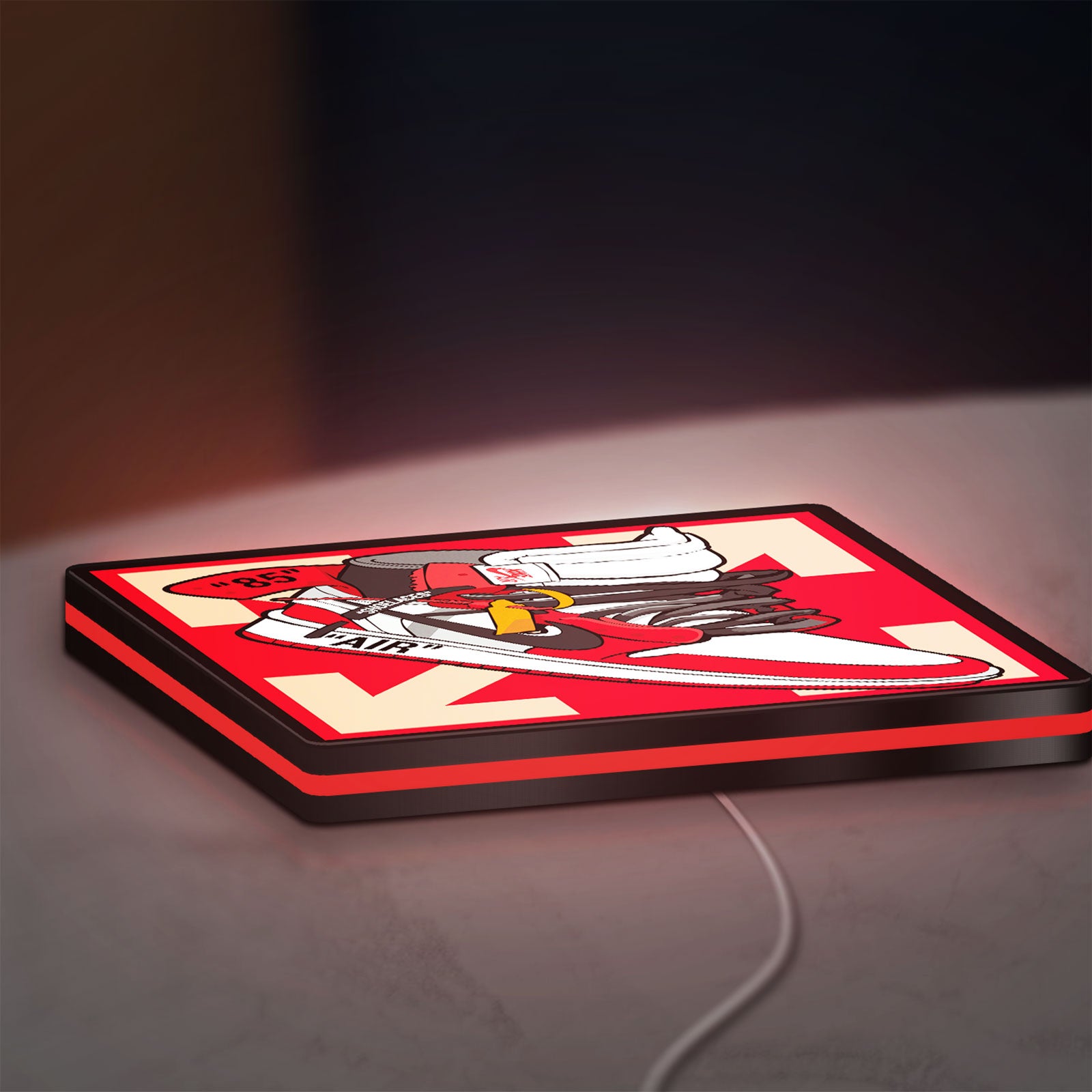 Nike Jordan Air Shoe LED lightbox lying flat on a desk with red glow
