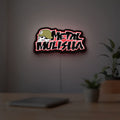 Metal Mulisha LED lightbox hanging on a room wall with soft red light