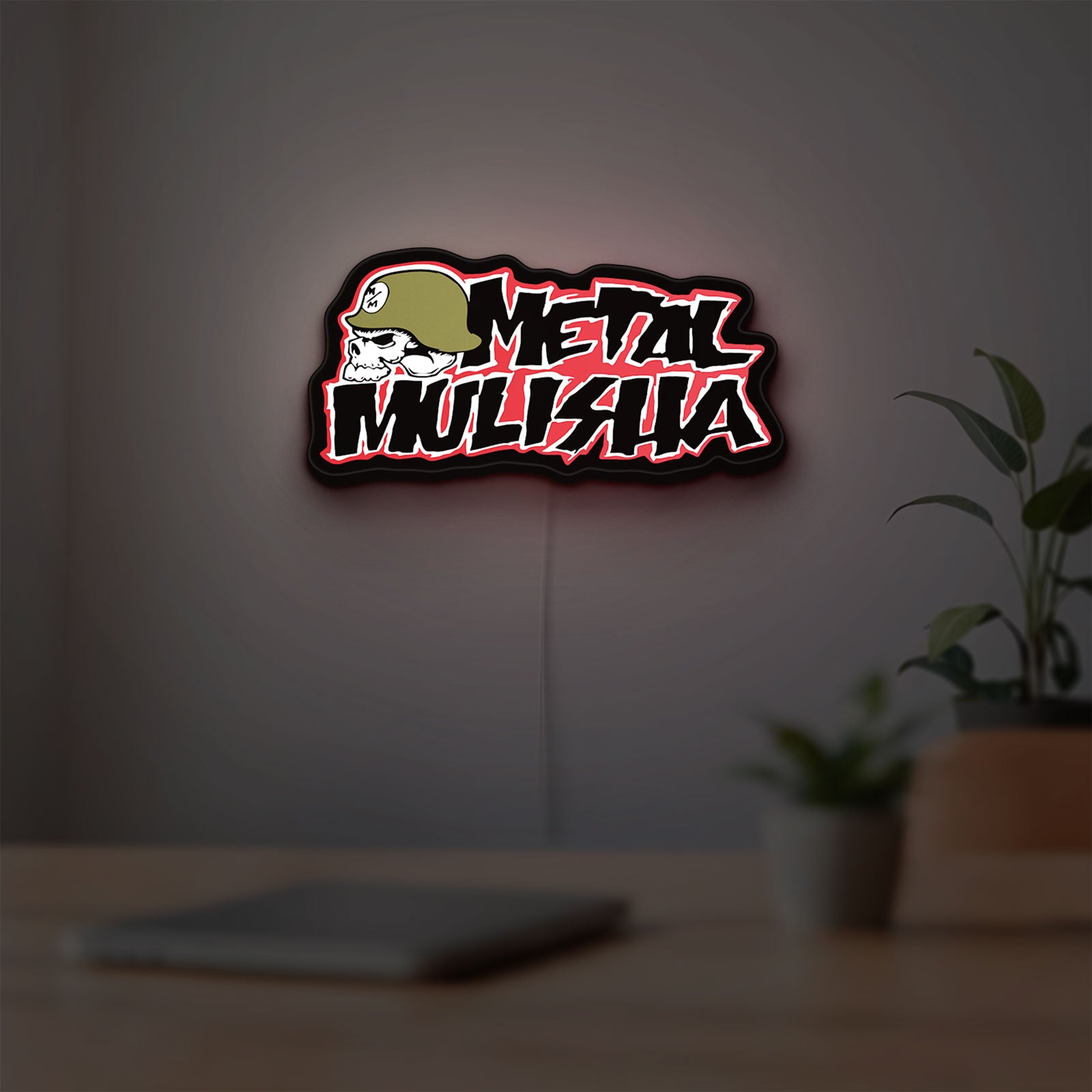 Metal Mulisha LED lightbox hanging on a room wall with soft red light