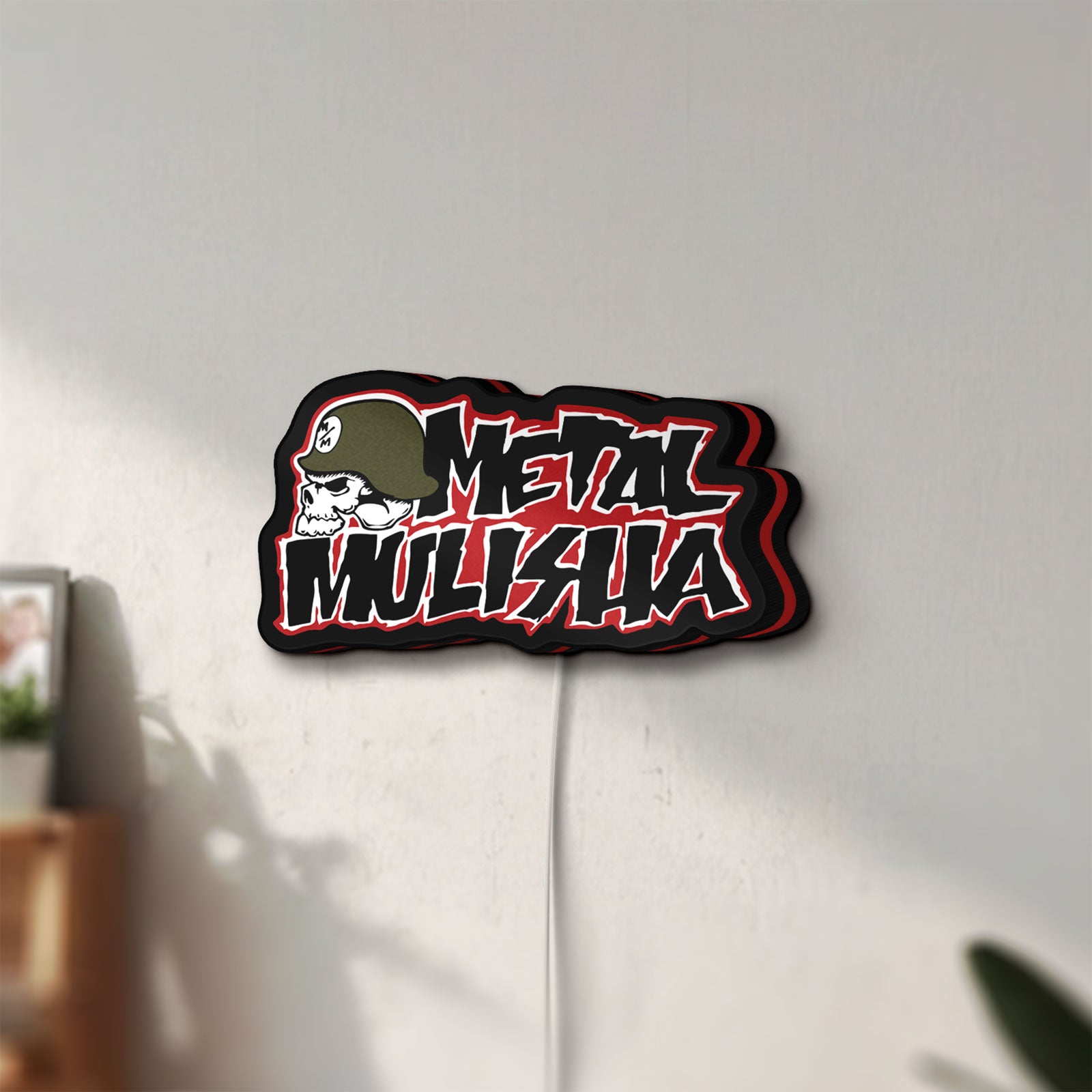 Unlit Metal Mulisha LED lightbox mounted on a wall in daylight