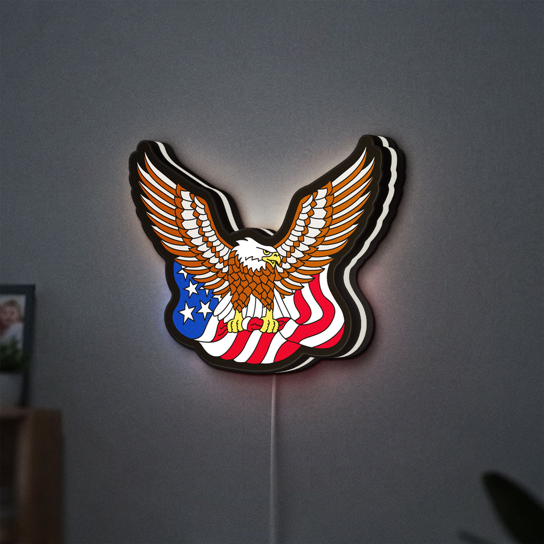 Eagle LED lightbox hanging on a wall with white glow