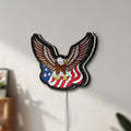 Unlit Eagle LED lightbox mounted on a wall in daylight