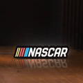 Front view of NASCAR LED lightbox sign glowing on a wooden desk