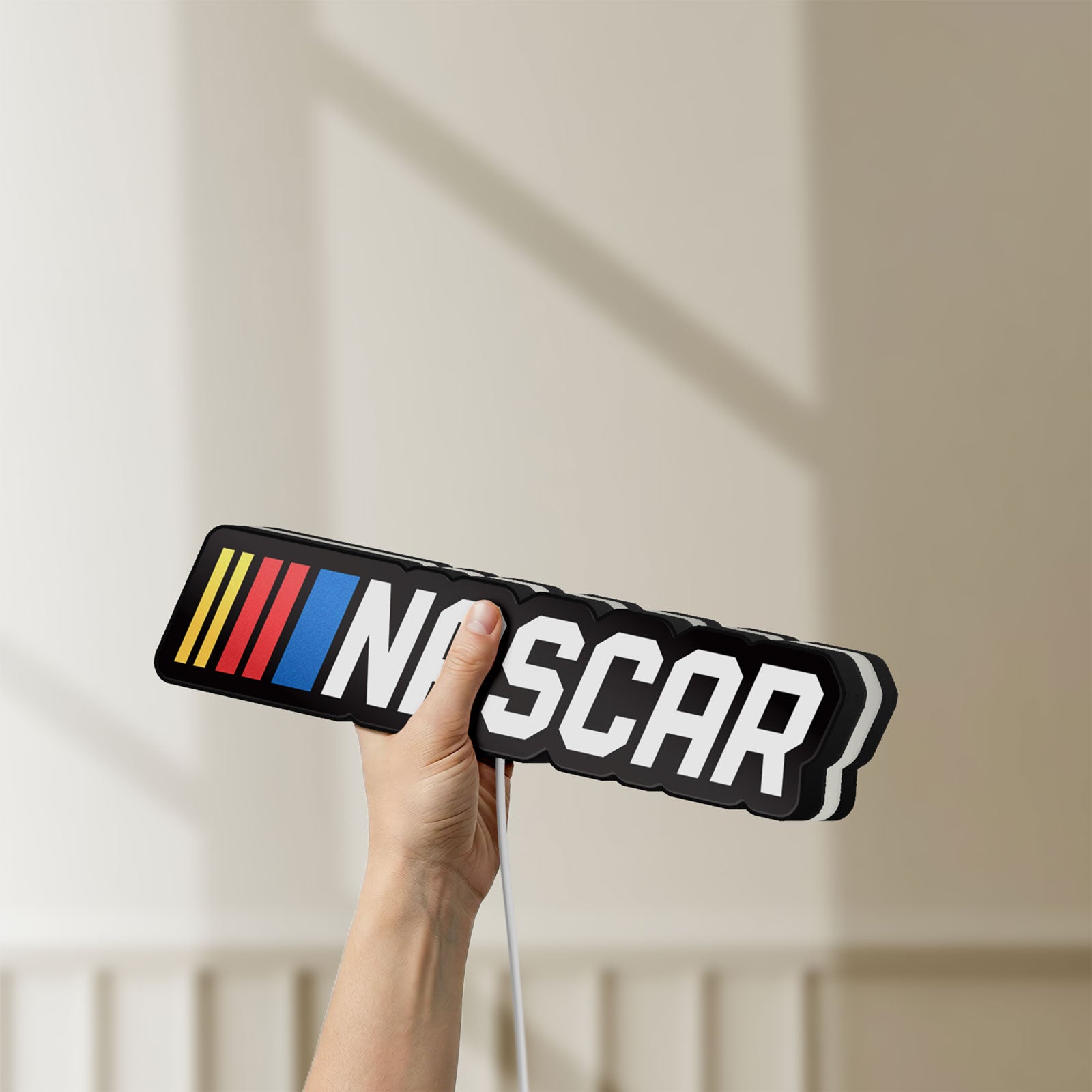 Unlit NASCAR LED lightbox held by hand to show size and details