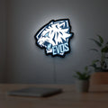 Evos LED lightbox hanging on a room wall with soft white light