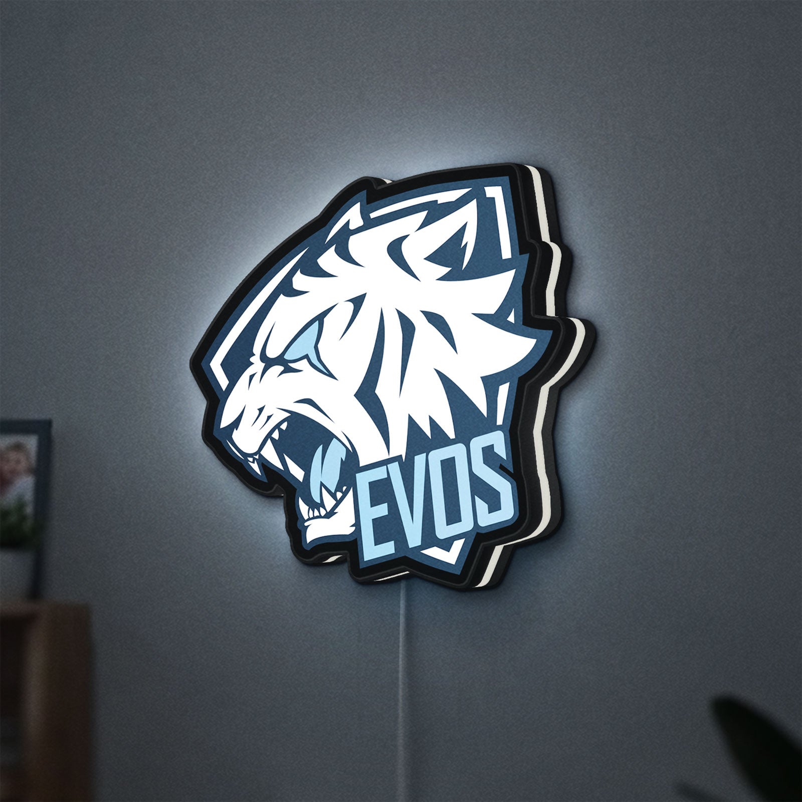Evos LED lightbox hanging on a wall with white glow