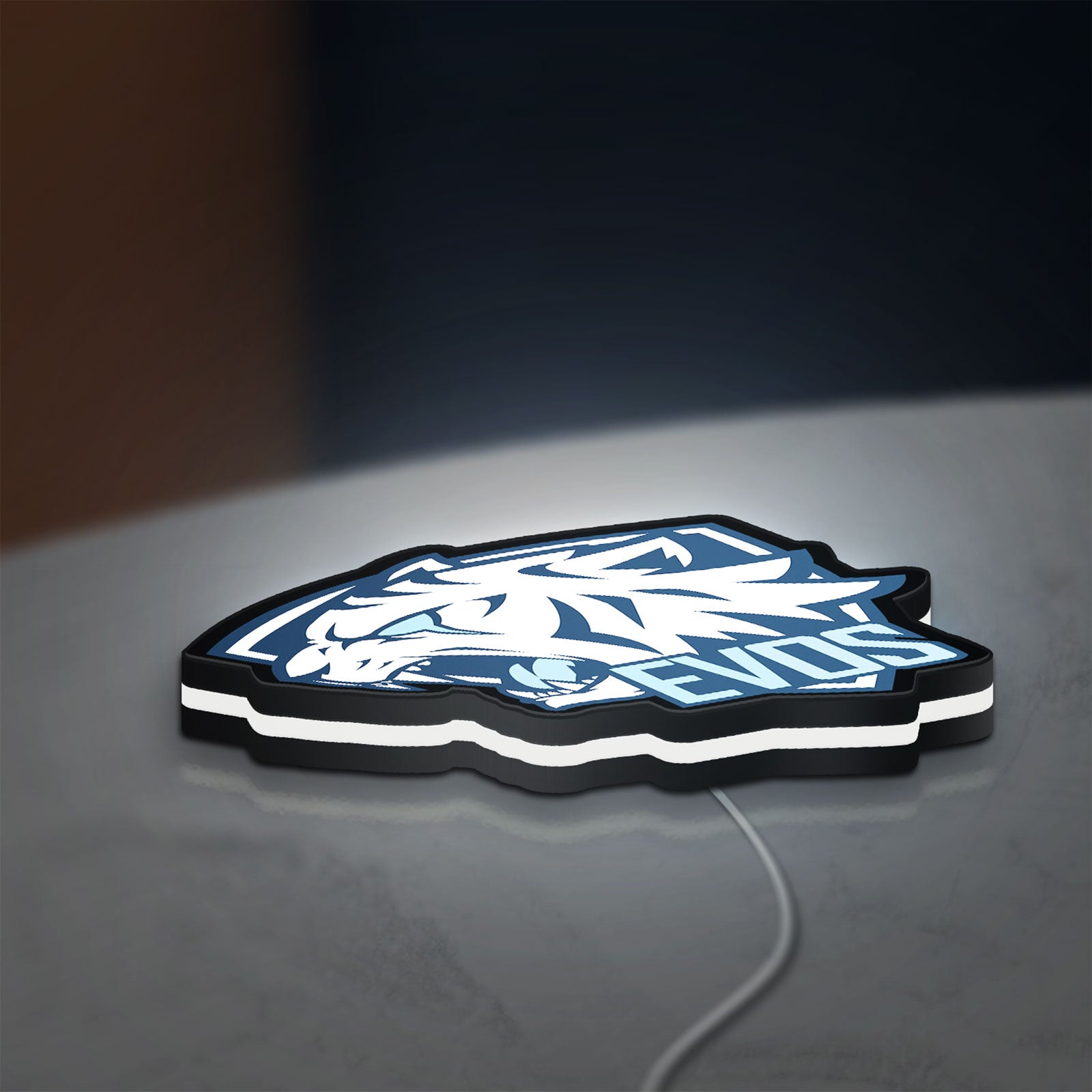 Evos LED lightbox lying flat on a desk with white glow