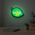 A Bug's Life LED lightbox hanging on a room wall with soft green light