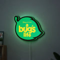 A Bug's Life LED lightbox hanging on a wall with green glow