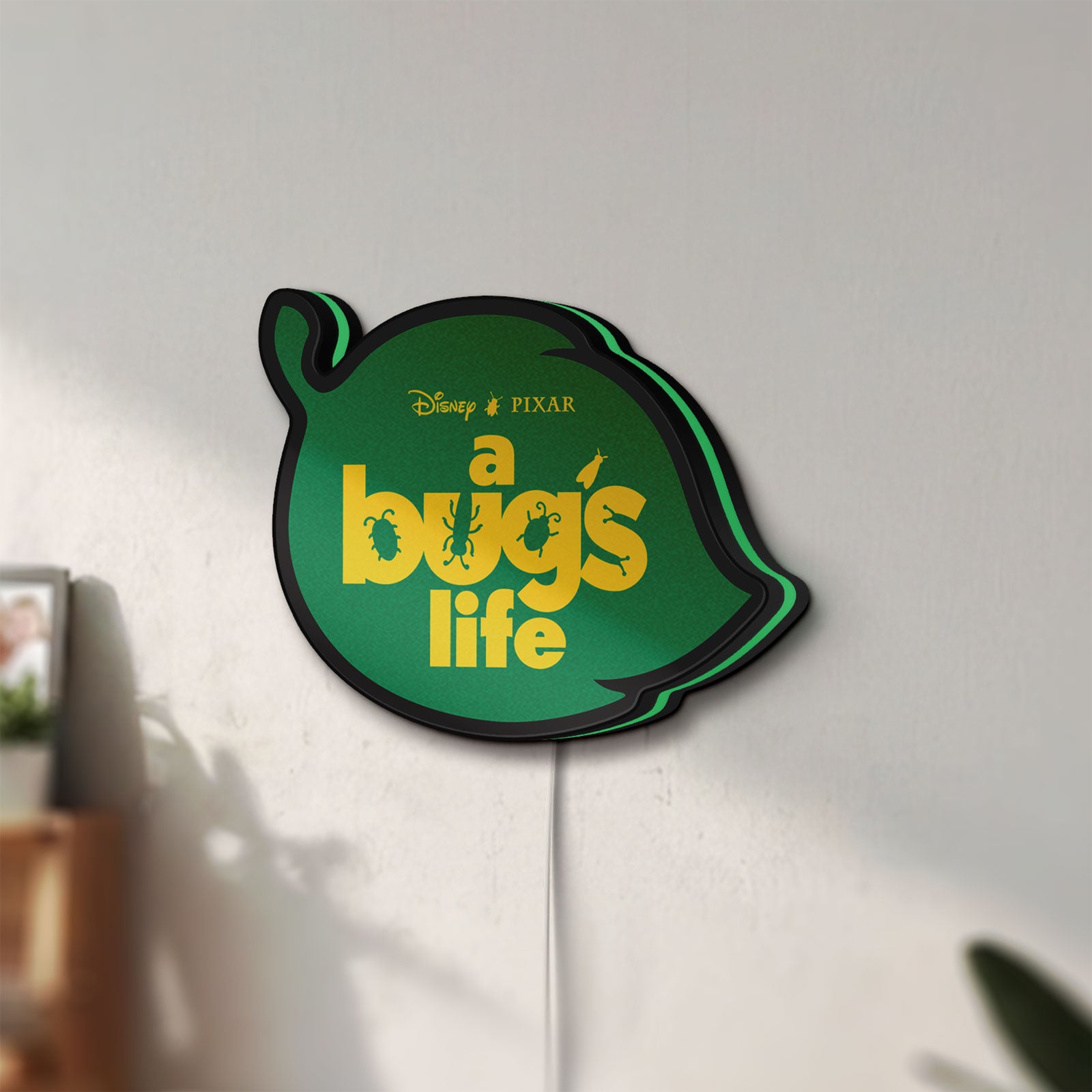 Unlit A Bug's Life LED lightbox mounted on a wall in daylight