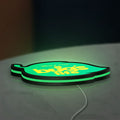 A Bug's Life LED lightbox lying flat on a desk with green glow