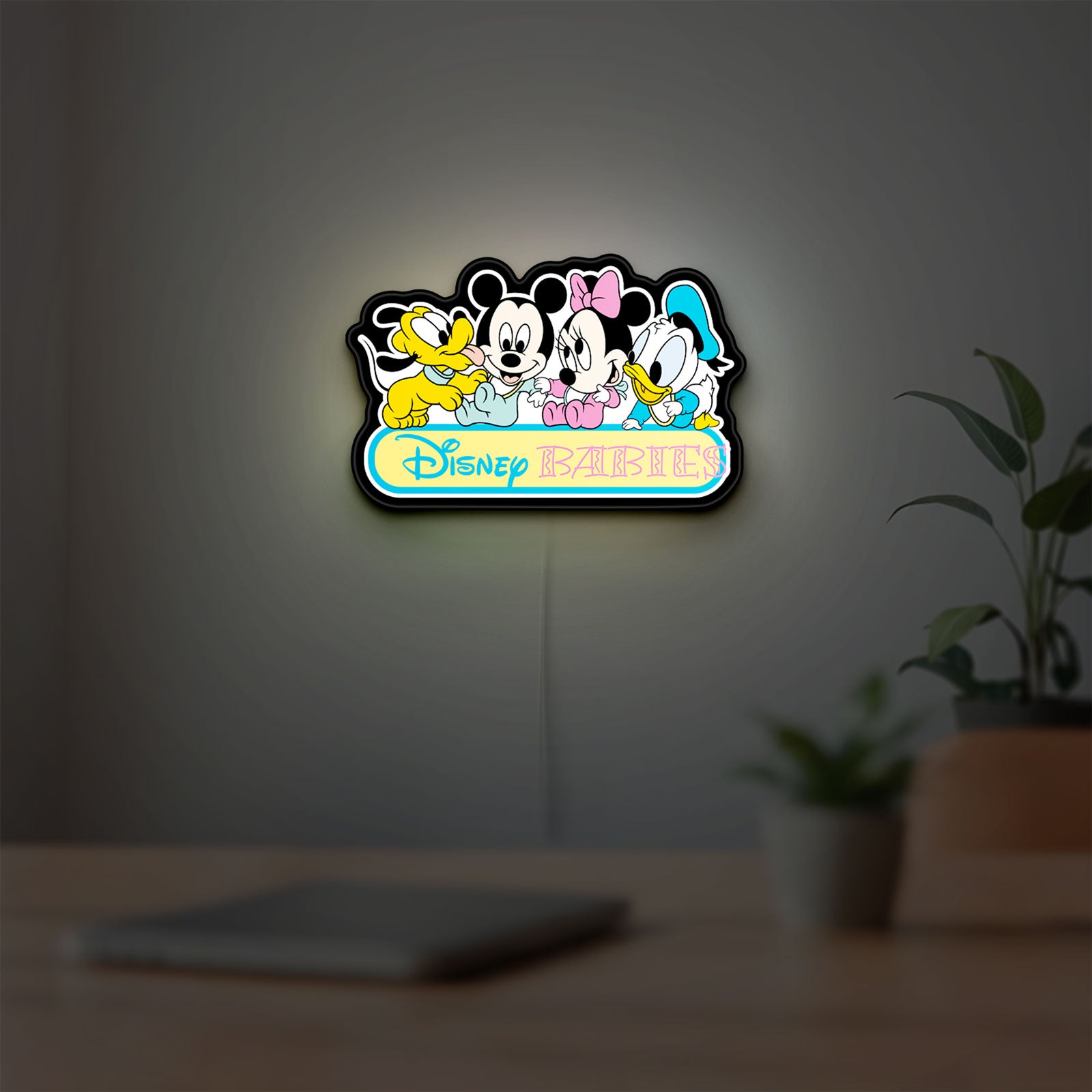 Disney Babies LED lightbox hanging on a room wall with soft white light