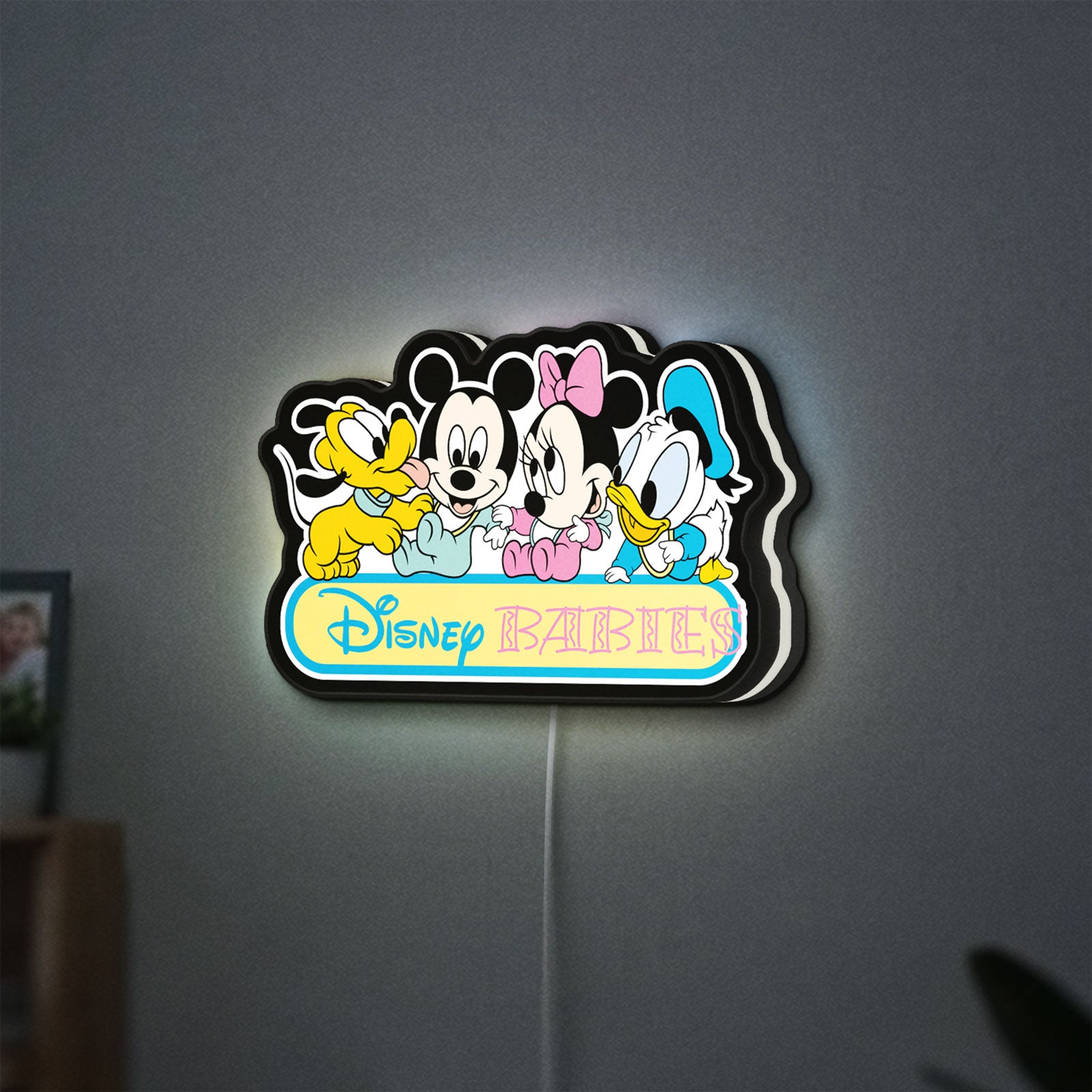 Disney Babies LED lightbox hanging on a wall with white glow