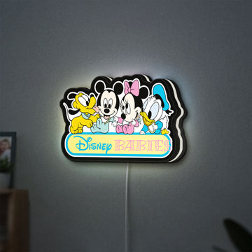 Disney Babies LED lightbox hanging on a wall with white glow