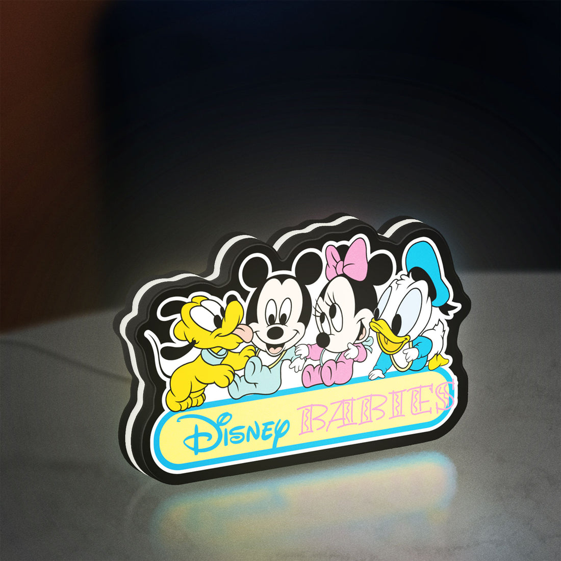 Disney Babies LED lightbox hanging on a wall with white glow