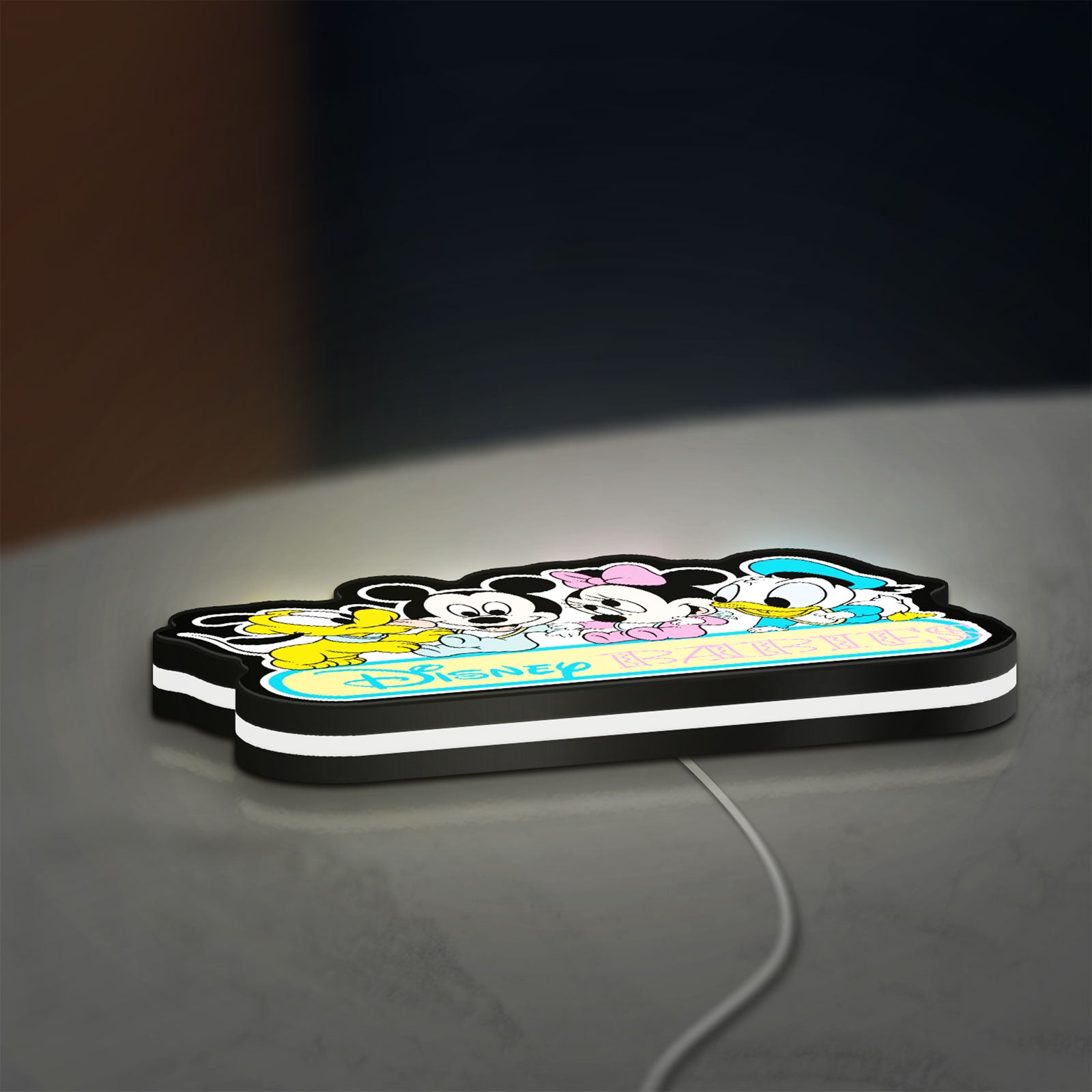 Disney Babies LED lightbox lying flat on a desk with white glow