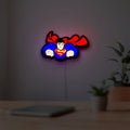 Superman S Shield LED lightbox hanging on a room wall with soft white light