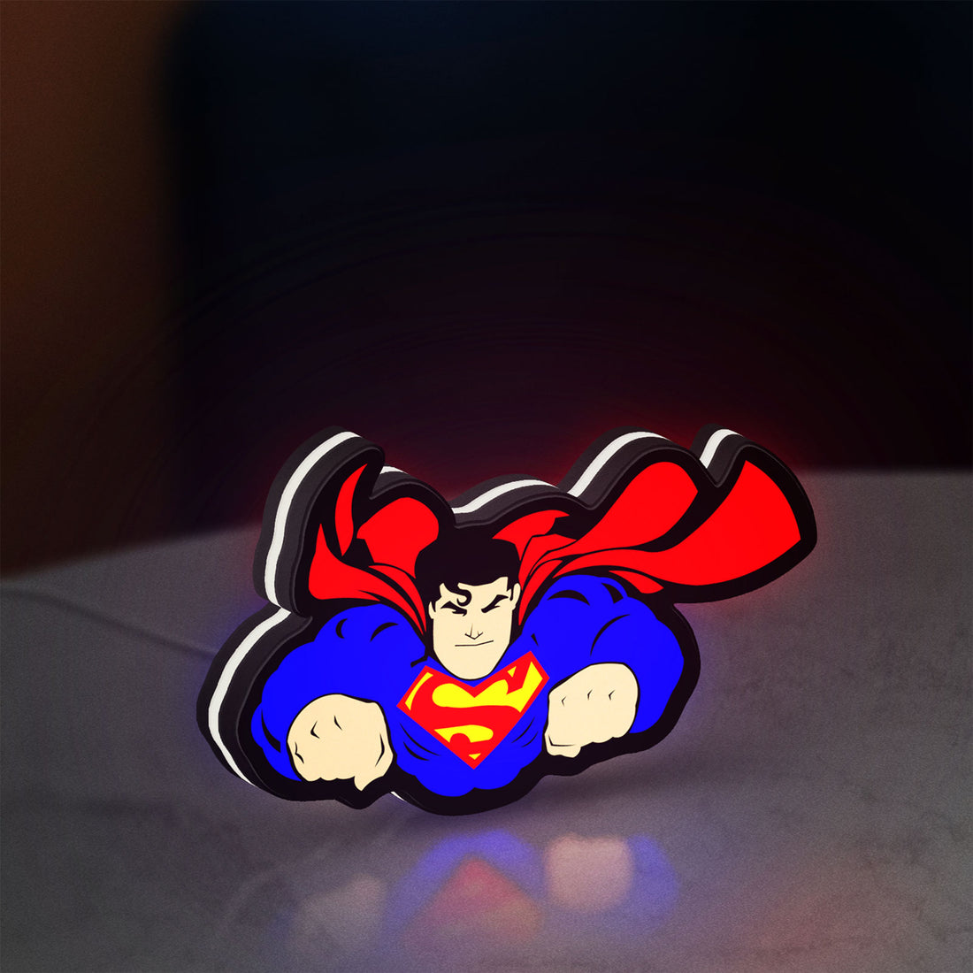 Superman S Shield LED lightbox hanging on a wall with white glow