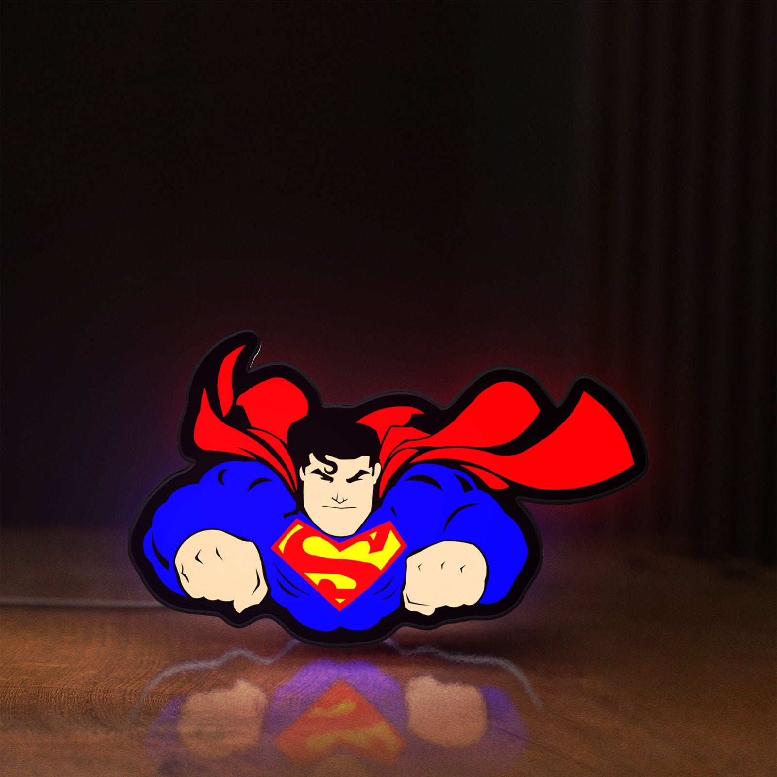 Front view of Superman S Shield LED lightbox sign glowing on a wooden desk