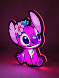 Illuminated angled view standing of Pink Stitch Illuminated Sign in 30cm, unique wall art for desk and room decor