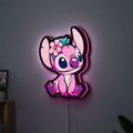 Pink Stitch LED lightbox hanging on a wall with pink glow